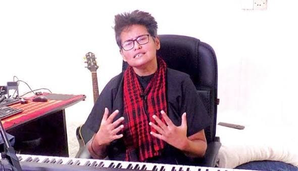 Shayan seated at a keyboard during rehearsal